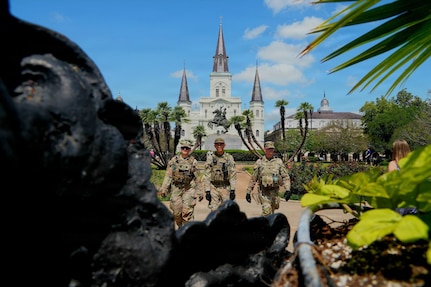 Louisiana National Guard Soldiers conduct a roving patrol as part of Task Force NOLA operations during French Quarter Fest.
