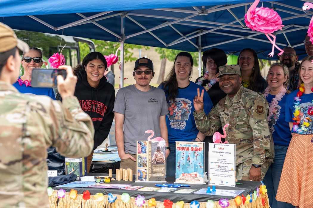 U.S. Air Force Chief Master Sgt. Clifford L. Lawton, right, 86th Airlift Wing command chief, poses for a group photo with members of the Kaiserslautern Military Community during Military Spouse Appreciation Day at Ramstein Air Base, Germany, May 8, 2026.
