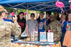 U.S. Air Force Chief Master Sgt. Clifford L. Lawton, right, 86th Airlift Wing command chief, poses for a group photo with members of the Kaiserslautern Military Community during Military Spouse Appreciation Day at Ramstein Air Base, Germany, May 8, 2026.
