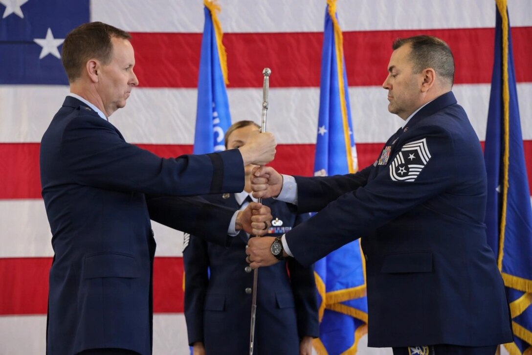 Passing of a ceremonial saber to Chief Master Sgt. Michael Alvarez
