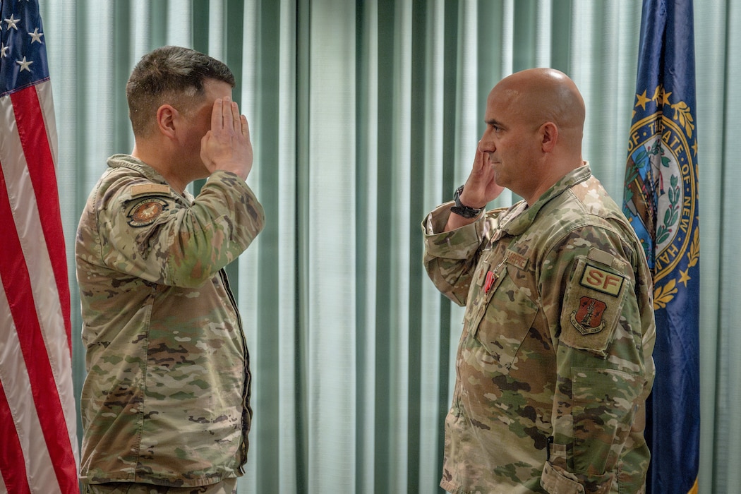 Maj. Joel Loranger, an operations officer with the 157th Air Refueling Wing, New Hampshire National Guard, salutes Maj. Michael Petrin, commander of the 157th SFS, at a recognition ceremony May 2, 2026 at Pease Air National Guard Base, New Hampshire.