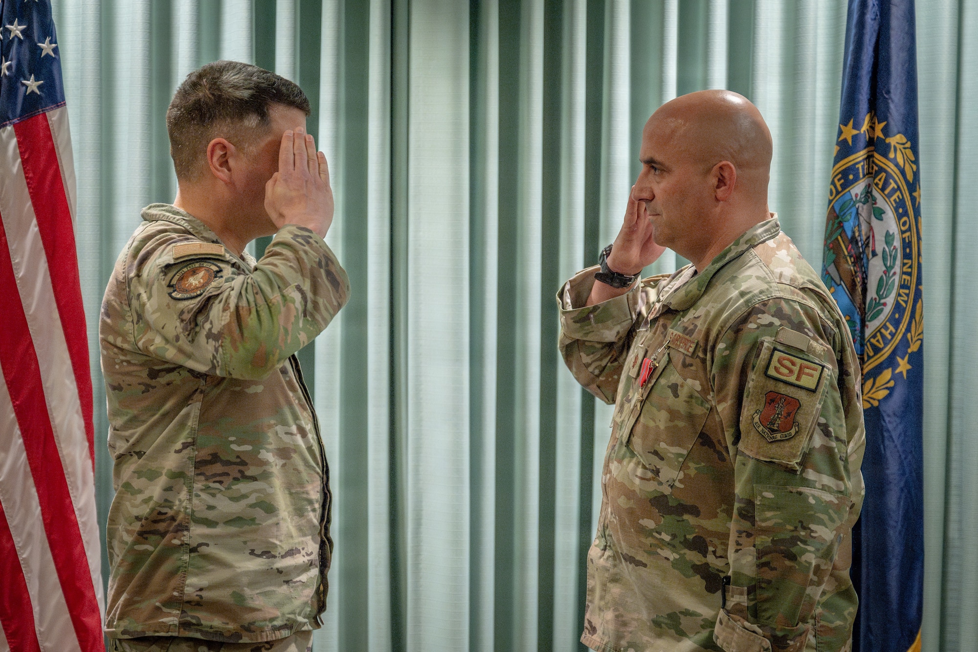 Maj. Joel Loranger, an operations officer with the 157th Air Refueling Wing, New Hampshire National Guard, salutes Maj. Michael Petrin, commander of the 157th SFS, at a recognition ceremony May 2, 2026 at Pease Air National Guard Base, New Hampshire.