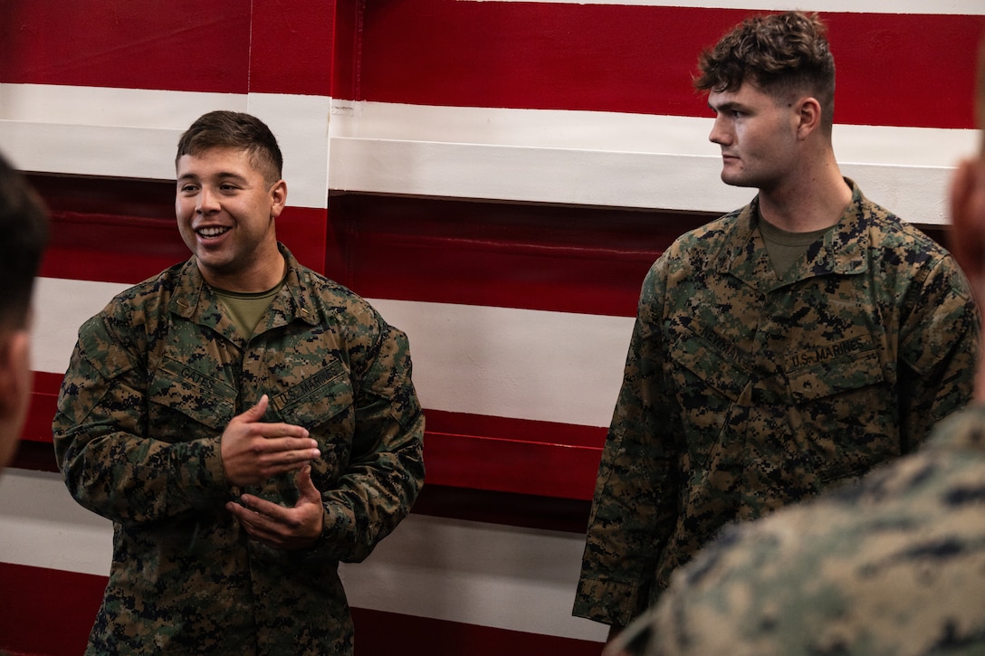 U.S. Marine Corps 1st Lt. Davin Gates, the executive officer of Lima Company, Battalion Landing Team 3/5, 11th Marine Expeditionary Unit, speaks to the audience during a promotion ceremony in the well deck of San Antonio-class amphibious transport dock ship USS Portland (LPD 27), in the Pacific Ocean, Dec. 7, 2025. The 11th MEU is currently underway aboard the Boxer Amphibious Ready Group in the U.S. 3rd Fleet area of operations conducting integrated training that enhances lethality and warfighting readiness. (U.S. Marine Corps photo by Lance Cpl. Luke Rodriguez)