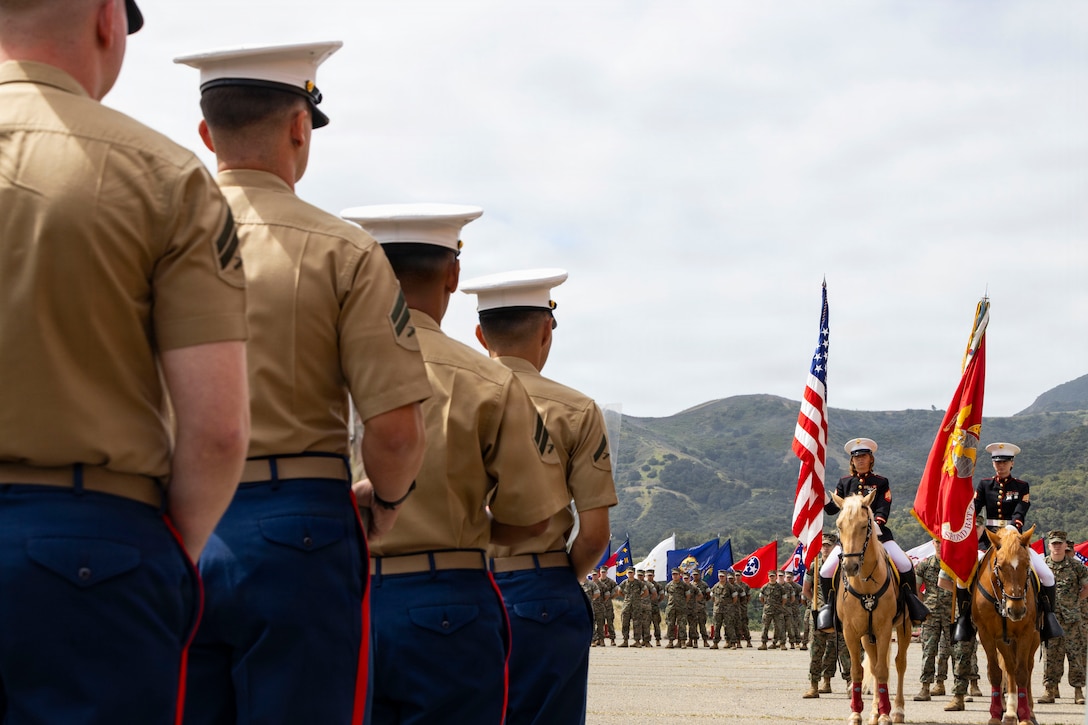The U.S. Marine Corps Mounted Color Guard presents the colors for a change of command ceremony for 2nd Battalion, 1st Marine Regiment, 1st Marine Division, at Marine Corps Base Camp Pendleton, Calif., May 1, 2026. The Marine Corps MCG’s presence at the change of command ceremony reflects its role in carrying forward Marine Corps ceremonial tradition, adding a distinctive mounted element that honors the formal transfer of command. (U.S. Marine Corps photo by Sgt. Davin Tenbusch)