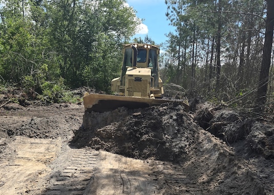A bulldozer assigned to the 877th Engineer Company, 878th Engineering Battalion, 648th Maneuver Enhancement Brigade, Georgia National Guard, clears burnt brush during wildland fire suppression efforts in Fruitland, Ga., April 29, 2026. The Georgia Department of Defense plays an integral role in declared emergencies by providing a versatile and ready force capable of responding to natural and manmade disasters across the United States.