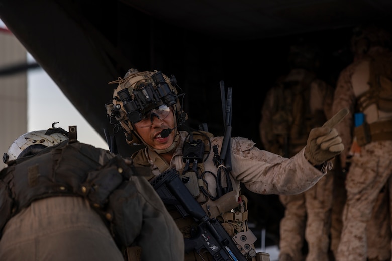 U.S. Marine Corps Capt. Nathaniel Armendariz, a platoon commander with the Maritime Raid Force, 11th Marine Expeditionary Unit, speaks to a crew chief during Realistic Urban Training at Marine Corps Air Station Yuma, Arizona, Nov. 10, 2025. RUT is a land-based training exercise that enables the 11th MEU to conduct expeditionary operations as a cohesive Marine Air-Ground Task Force in preparation for amphibious operations alongside the U.S. Navy. (U.S. Marine Corps photo by Cpl. Oliver Nisbet)