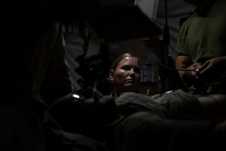 U.S. Navy Hospital Corpsman 2nd Class Billie Jo Vo with the 11th Marine Expeditionary Unit, I Marine Expeditionary Force, checks medication dosage while providing aid to a simulated casualty during Realistic Urban Training at Marine Corps Air Station Yuma, Arizona, Nov. 10, 2025. RUT is a land-based training exercise that enables the 11th MEU to conduct expeditionary operations as a cohesive Marine Air-Ground Task Force in preparation for amphibious operations alongside the U.S. Navy. (U.S. Marine Corps photo by Cpl. Oliver Nisbet)