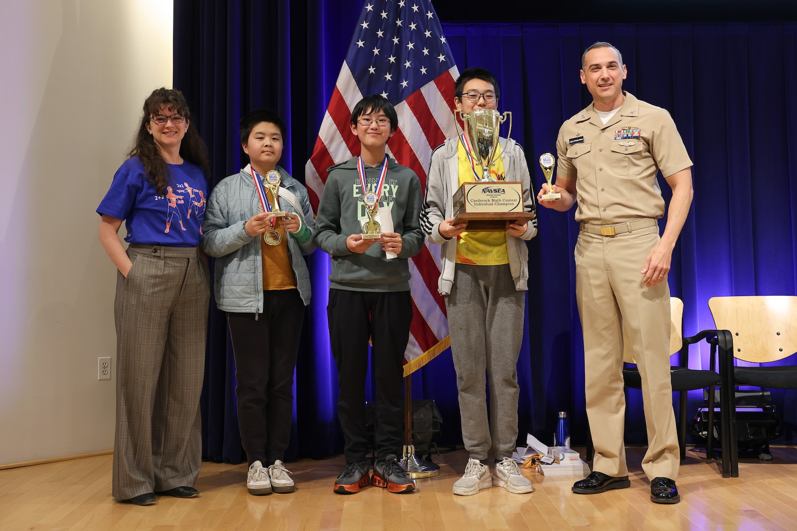 Winners of the “Countdown Round” pose with their trophies alongside Carderock leadership during the 15th annual Carderock Math Contest (CMC) at Naval Surface Warfare Center, Carderock Division