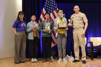 Winners of the “Countdown Round” pose with their trophies alongside Carderock leadership during the 15th annual Carderock Math Contest (CMC) at Naval Surface Warfare Center, Carderock Division