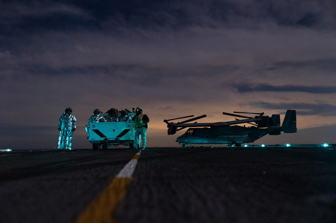 U.S. Sailors assigned to Wasp-class amphibious assault ship USS Boxer (LHD 4), supervise flight deck operations in the Pacific Ocean, Dec. 3, 2025. The 11th MEU is currently underway aboard the Boxer Amphibious Ready Group in the U.S. 3rd Fleet area of operations conducting integrated training that enhances lethality and warfighting readiness. (U.S. Marine Corps photo by Cpl. Oliver Nisbet)