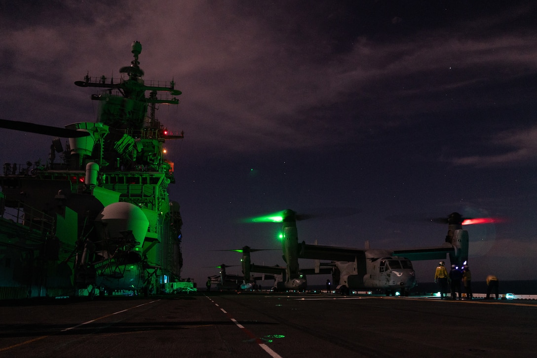 U.S. Marine Corps MV-22B Ospreys with Marine Medium Tiltrotor Squadron (VMM) 163 (Reinforced), 11th Marine Expeditionary Unit, and U.S. Sailors conduct night deck landing qualifications aboard Wasp-class amphibious assault ship USS Boxer (LHD 4) in the Pacific Ocean, Dec. 3, 2025. The 11th MEU is currently underway aboard the Boxer Amphibious Ready Group in the U.S. 3rd Fleet area of operations conducting integrated training that enhances lethality and warfighting readiness. (U.S. Marine Corps photo by Cpl. Oliver Nisbet)