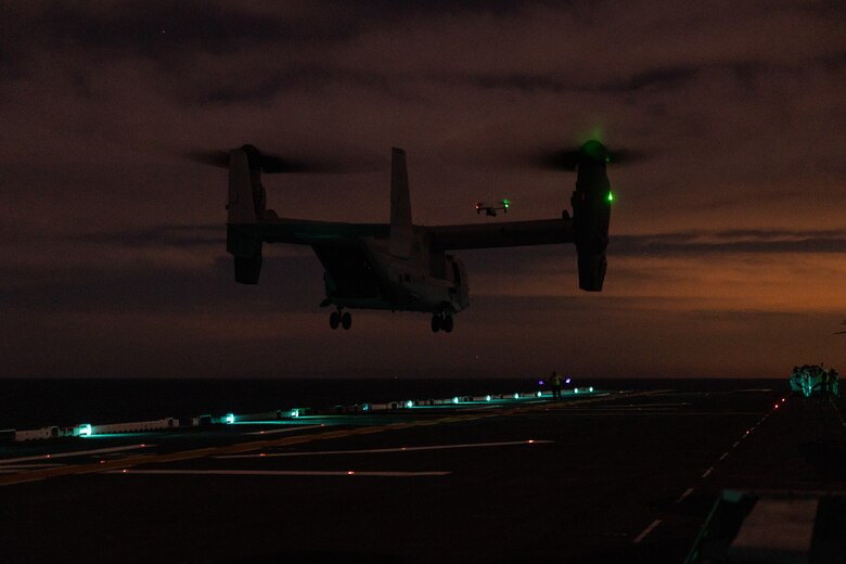 U.S. Marine Corps MV-22B Ospreys with Marine Medium Tiltrotor Squadron (VMM) 163 (Reinforced), 11th Marine Expeditionary Unit, take off during night deck landing qualifications aboard Wasp-class amphibious assault ship USS Boxer (LHD 4) in the Pacific Ocean, Dec. 3, 2025. The 11th MEU is currently underway aboard the Boxer Amphibious Ready Group in the U.S. 3rd Fleet area of operations conducting integrated training that enhances lethality and warfighting readiness. (U.S. Marine Corps photo by Cpl. Oliver Nisbet)