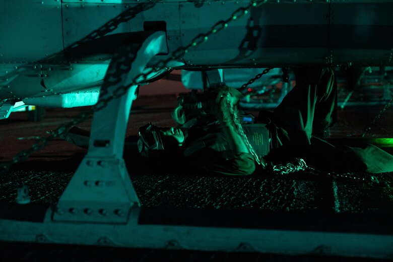 A U.S. Marine with Marine Medium Tiltrotor Squadron (VMM) 163 (Reinforced), 11th Marine Expeditionary Unit, chains down a UH-1Y Venom helicopter to the flight deck of Wasp-class amphibious assault ship USS Boxer (LHD 4) in the Pacific Ocean, Dec. 3, 2025. The 11th MEU is currently underway aboard the Boxer Amphibious Ready Group in the U.S. 3rd Fleet area of operations conducting integrated training that enhances lethality and warfighting readiness. (U.S. Marine Corps photo by Cpl. Oliver Nisbet)