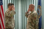 Maj. Joel Loranger, an operations officer with the 157th Air Refueling Wing, New Hampshire National Guard, salutes Maj. Michael Petrin, commander of the 157th SFS, at a recognition ceremony May 2, 2026 at Pease Air National Guard Base, New Hampshire. Loranger was awarded the Bronze Star Medal for distinguished accomplishments while deployed to Iraq, where he led security forces through a series of enemy aerial attacks during a six-month combat tour. (U.S. Air National Guard photo by Tech. Sgt. Timothy Hayden)