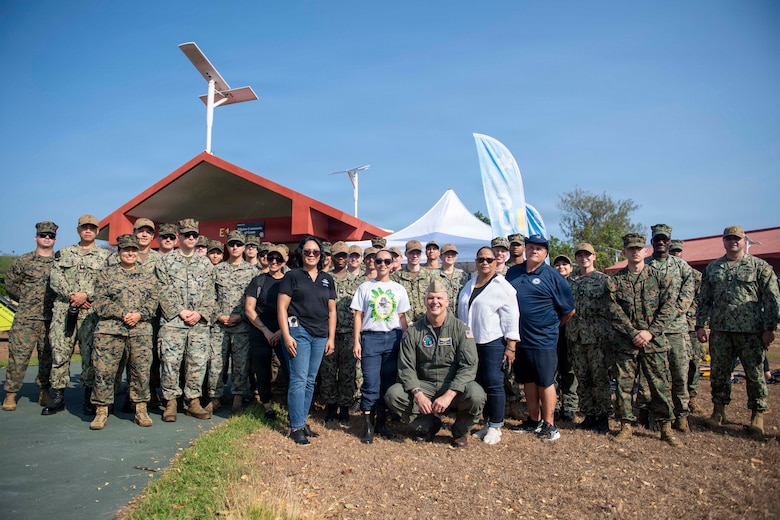 U.S. Sailors and Marines assigned to the Boxer Amphibious Ready Group (ARG) and 11th Marine Expeditionary Unit (MEU), pose for a photo during a beach cleanup on Ypao Beach, Guam, April 20, 2026. Wasp-class amphibious assault ship USS Boxer (LHD 4), flagship of the Boxer Amphibious Ready Group, and elements of the 11th MEU are providing vital defense support to civil authorities, contributing to crisis response and recovery efforts in the wake of Super Typhoon Sinlaku. In supporting FEMA and local governments, Boxer ARG fills critical capability gaps to enable restoration of essential services by civil authorities. (U.S. Navy photo by Mass Communication Specialist Seaman Apprentice Sailor O’Rear