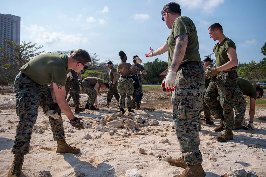 U.S. Sailors and Marines assigned to the Boxer Amphibious Ready Group (ARG) and the 11th Marine Expeditionary Unit (MEU), remove debris during a beach cleanup on Ypao Beach, Guam, April 20, 2026. Wasp-class amphibious assault ship USS Boxer (LHD 4), flagship of the Boxer ARG, and elements of the 11th MEU, are providing vital defense support to civil authorities, contributing to crisis response and recovery efforts in the wake of Super Typhoon Sinlaku. In supporting FEMA and local governments, Boxer ARG fills critical capability gaps to enable restoration of essential services by civil authorities. (U.S. Navy photo by Mass Communication Specialist Seaman Apprentice Sailor O’Rear)