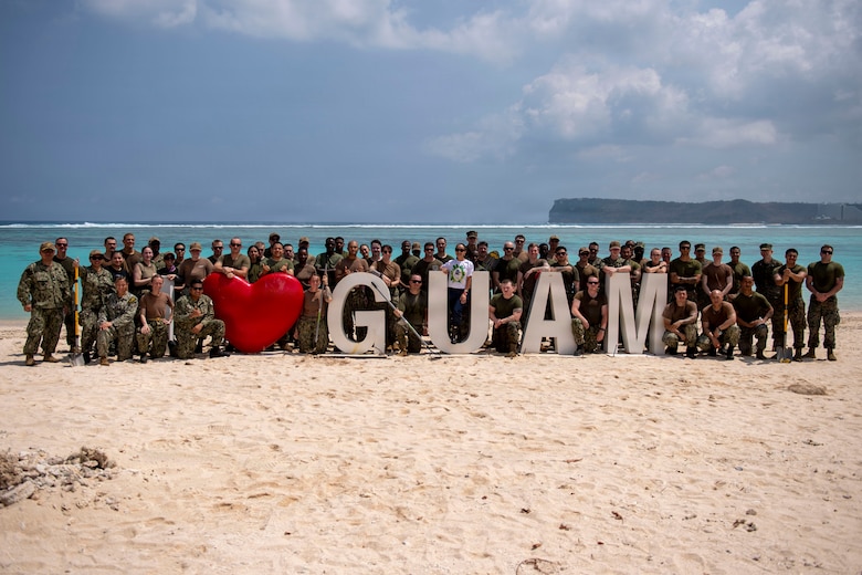 U.S. Sailors and Marines assigned to the Boxer Amphibious Ready Group (ARG) and 11th Marine Expeditionary Unit (MEU), pose for a photo following a beach cleanup on Ypao Beach, Guam, April 20, 2026. Wasp-class amphibious assault ship USS Boxer (LHD 4), flagship of the Boxer Amphibious Ready Group, and elements of the 11th MEU, are providing vital defense support to civil authorities, contributing to crisis response and recovery efforts in the wake of Super Typhoon Sinlaku. In supporting FEMA and local governments, Boxer ARG fills critical capability gaps to enable restoration of essential services by civil authorities. (U.S. Navy photo by Mass Communication Specialist Seaman Apprentice Sailor O’Rear)