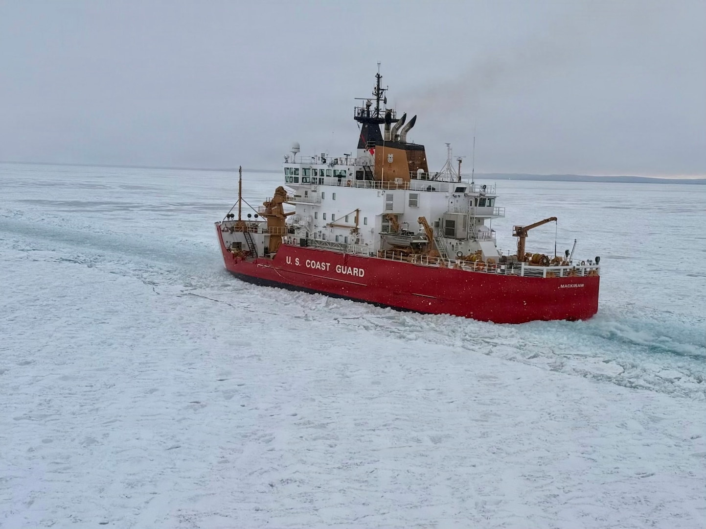 U.S. Coast Guard Cutter Mackinaw (WLBB 30) crew conducts track maintenance during a joint exercise with another crew U.S. Coast Guard Air Station Traverse City on the St. Mary's River, Feb. 5, 2026. The Mackinaw was clearing ice in support of Operation Taconite, which aids the flow of commerce during the winter months on the Great Lakes. (U.S. Coast Guard photo by Commander Andrew Lund)