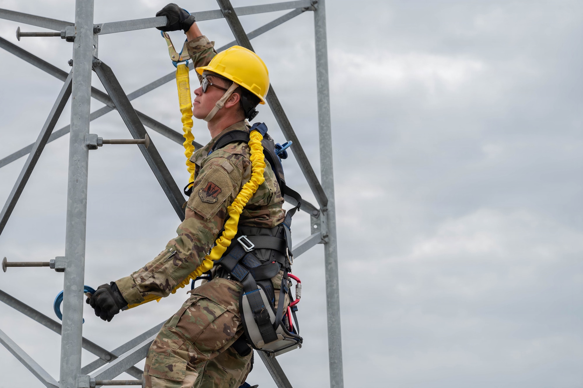 Airman climbs a tower.