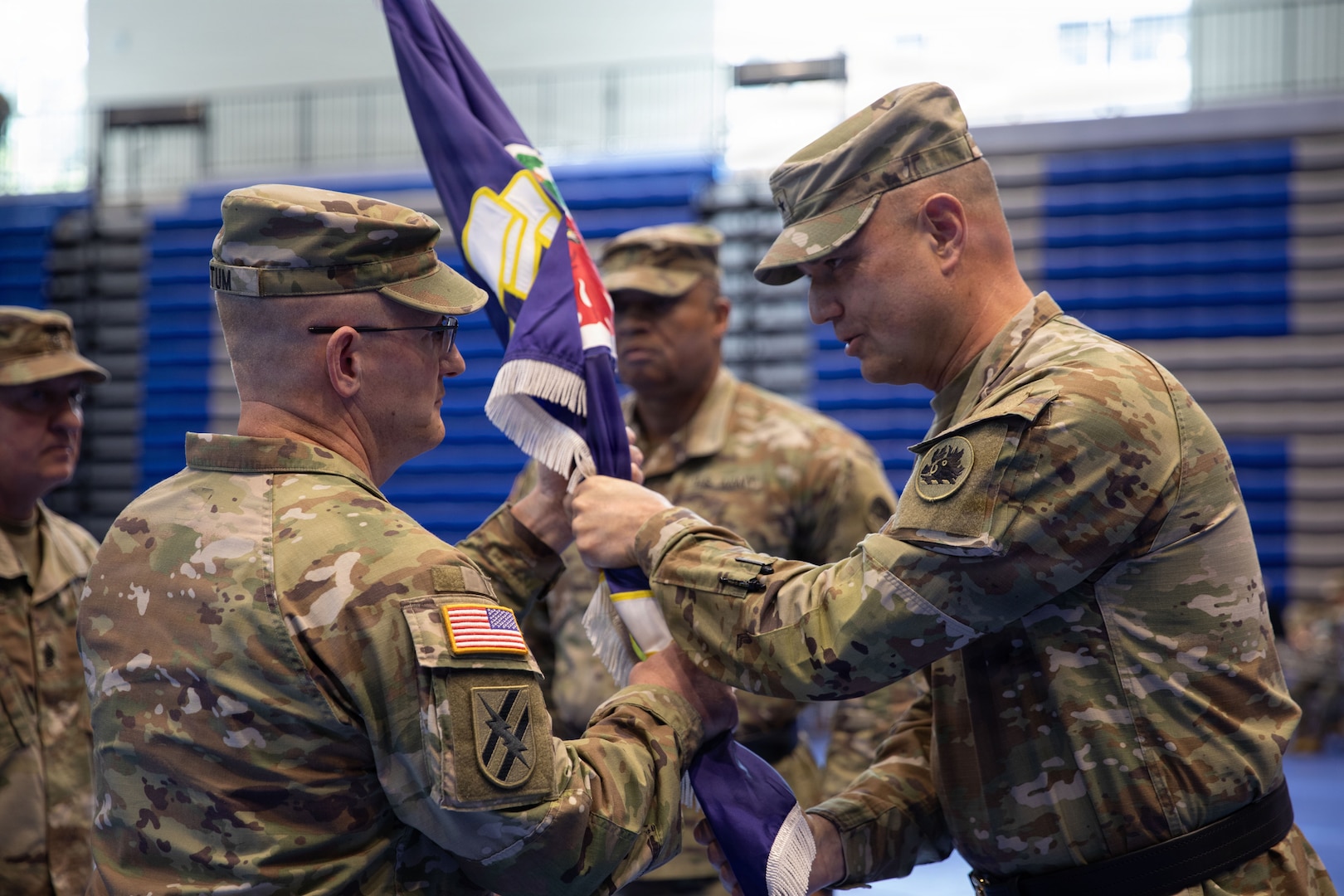 U.S. Army Brig. Gen. Jason Fryman, commander of the Georgia Army National Guard, passes the 78th Troop Command colors to incoming commander U.S. Army Col. Rodney K. Tatum Jr. during the unit’s change of command ceremony at Campbell High School in Smyrna, Georgia, May 2, 2026. The passing of the colors symbolizes the transfer of authority and responsibility from the outgoing commander to the incoming commander. (U.S. Army National Guard photo by Sgt. Cameron Boyd)