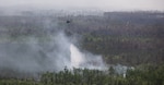 A UH-60 Blackhawk helicopter crew with Charlie Company, 1st General Support Aviation Battalion, 106th Aviation Regiment, 78th Aviation Troop Command, Georgia Army National Guard, drops water from its Bambi Bucket on an active fire during the wildfire suppression efforts in Pineland, Georgia, April 25, 2026. The Georgia Department of Defense plays an integral role in declared emergencies by providing a versatile and ready force capable of responding to natural and manmade disasters across the United States. (U.S. Army National Guard photo by Sgt. Jordan McNeal)