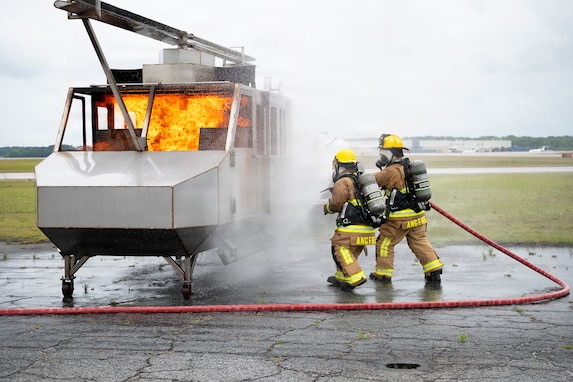 U.S. Airmen assigned to the 165th Civil Engineer Squadron, 165th Airlift Wing, Georgia Air National Guard, extinguish a fire during a readiness exercise at the Savannah Air National Guard Base, Georgia, May 1, 2026. This exercise involved the simulated deployment of units from across the installation to validate their readiness to sustain operations in a contested environment. (U.S. Air National Guard photo by Senior Airman Selena Acosta)