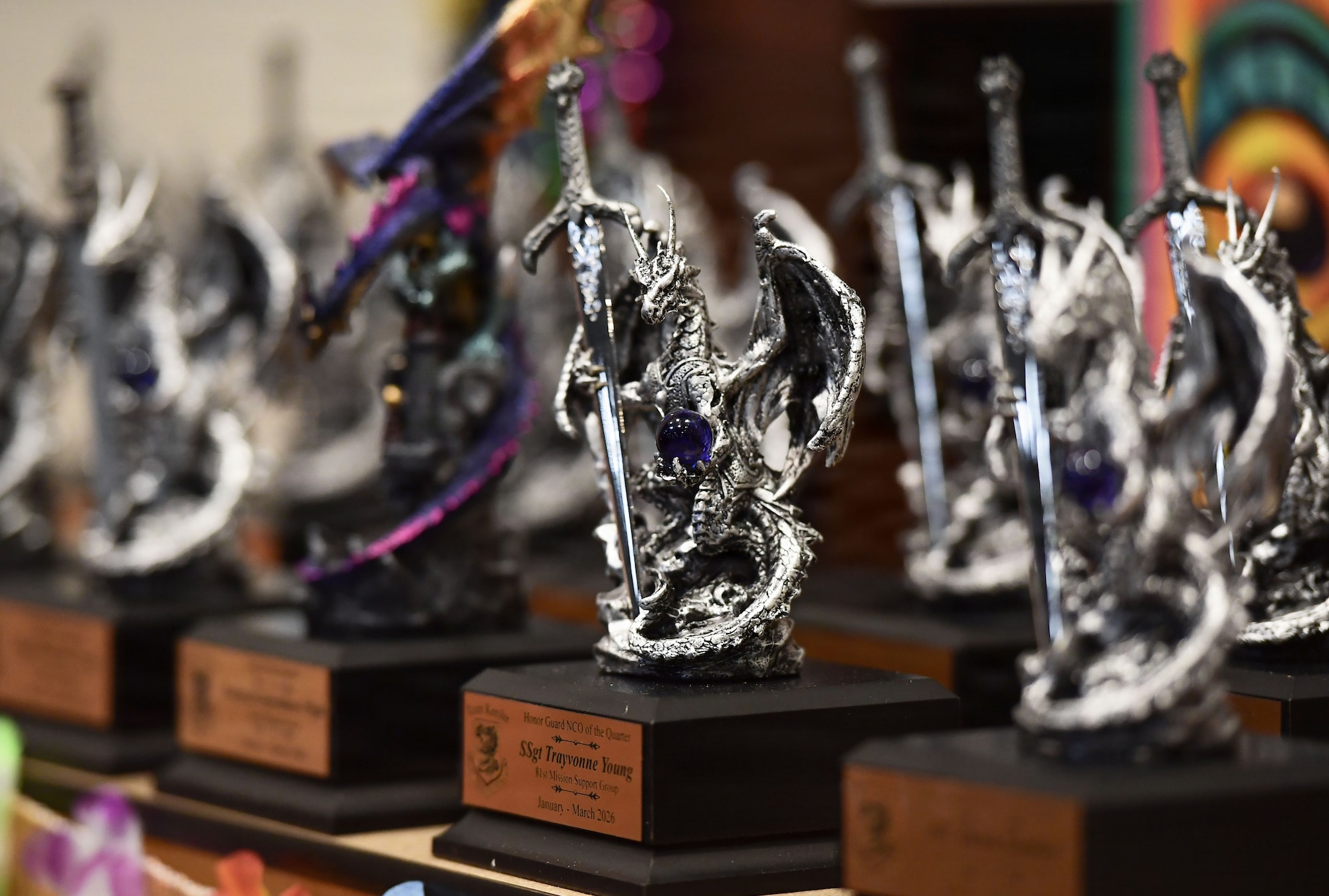 Dragon trophies are on display on a table.