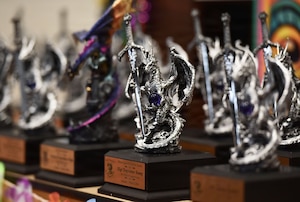 Dragon trophies are on display on a table.