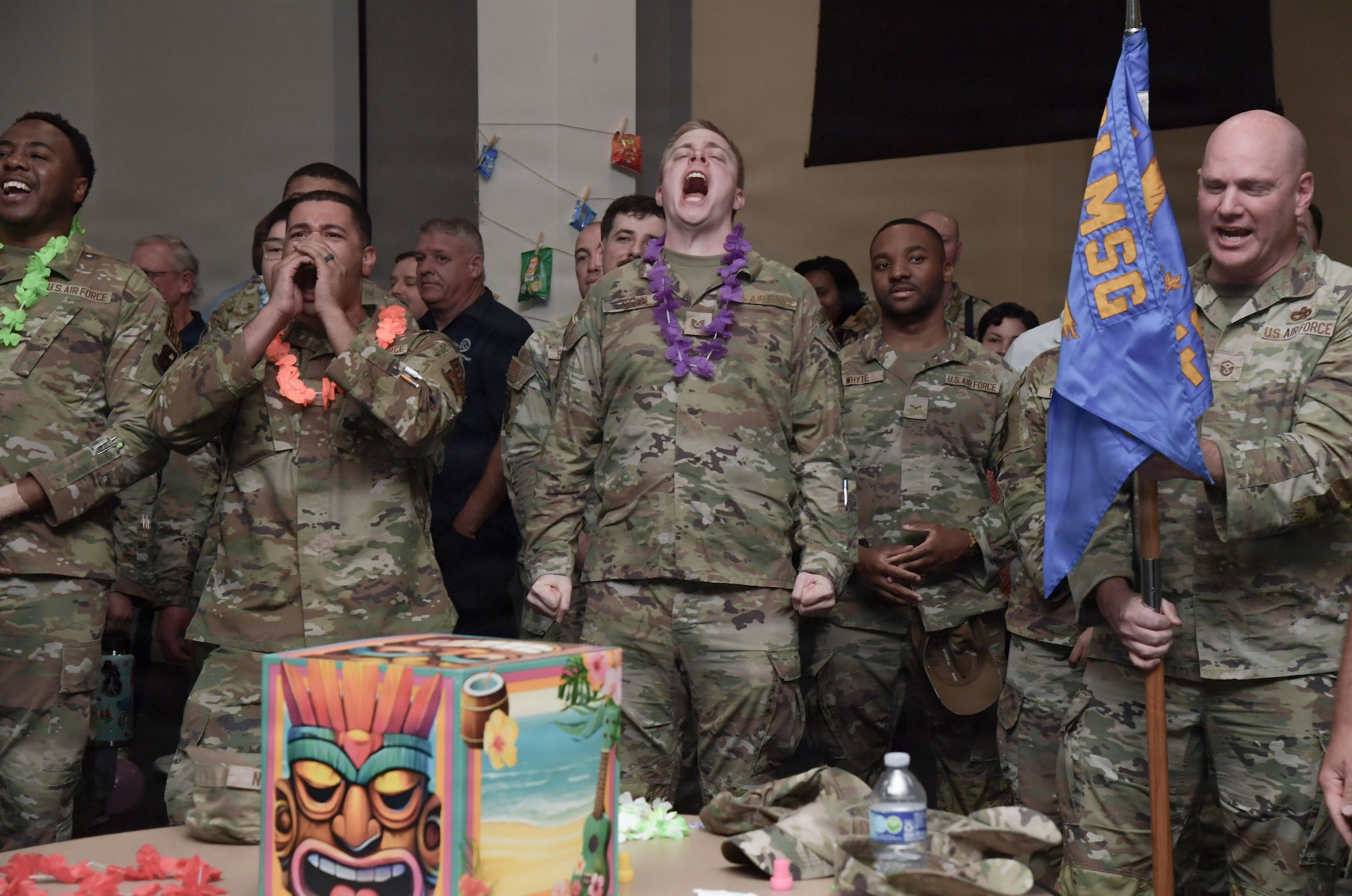 People in military uniform cheer and applaud.