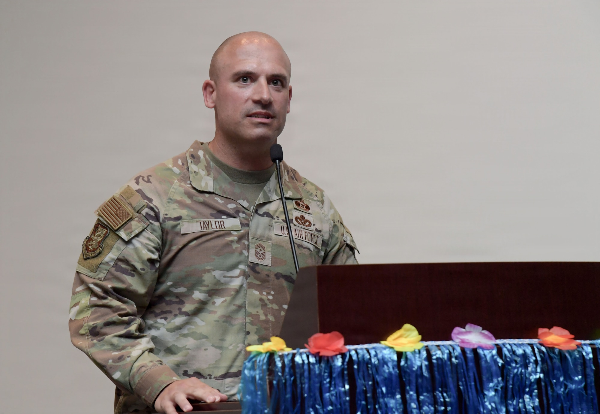 A man speaks from behind a podium.
