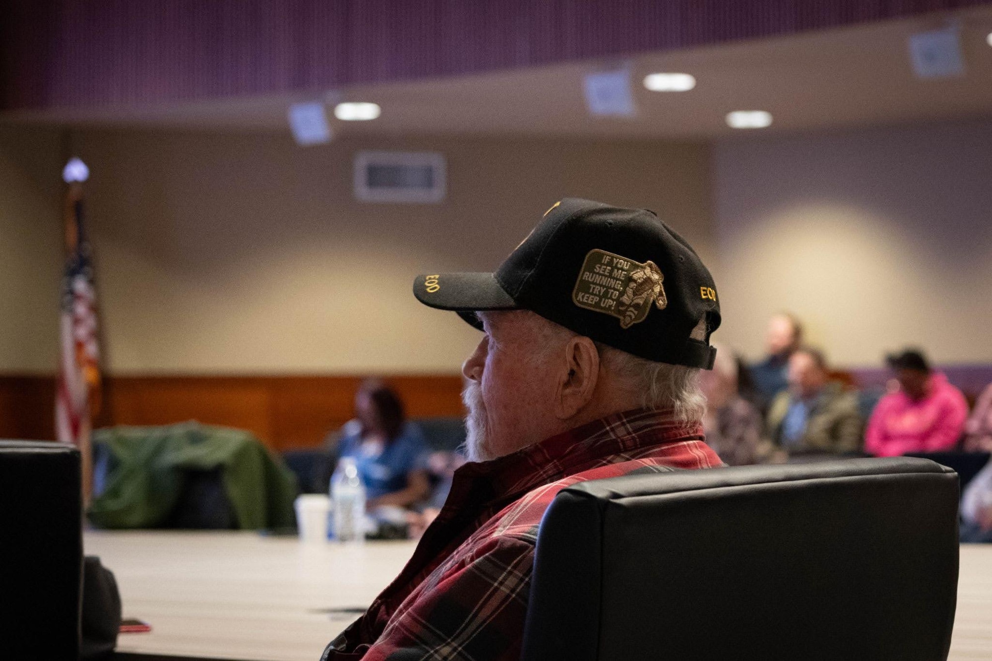 A veteran sits and listens to a speech during the Retiree Appreciation Day event on Joint Base Elmendorf-Richardson, Alaska, May 1, 2026. The ceremony honored military retirees, connecting them with installation resources and celebrating their contributions to the military community. (U.S. Air Force photo by Airman 1st Class Owen Davies)