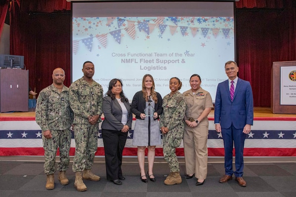 260504-N-KC192-1056 PORTSMOUTH, Va. (May 4, 2026) Sailors and staff with Naval Medical Forces Atlantic N42 Fleet Support and Logistics Team are presented the Cross-Functional Team of the Year Award by Dr. Michael McGinnis, Bureau of Medicine and Surgery (BUMED) executive director, during the 2026 Medical Logistics Symposium held on board Naval Medical Center Portsmouth, May 4, 2026. The team was recognized for driving logistics innovation and standardization, improving the delivery, accountability and readiness of medical materiel supporting deployed forces. The Navy Medicine Logistics Symposium aims to maintain a common operating picture and update the Medical Logistics community regarding the fiscal year 2026 Navy Medicine Campaign Order and the Navy MEDLOG goal to build a logistics system that delivers ready operational units to support the Naval Strategy. (U.S. Navy photo by Mass Communication Specialist Second Class Levi Decker)
