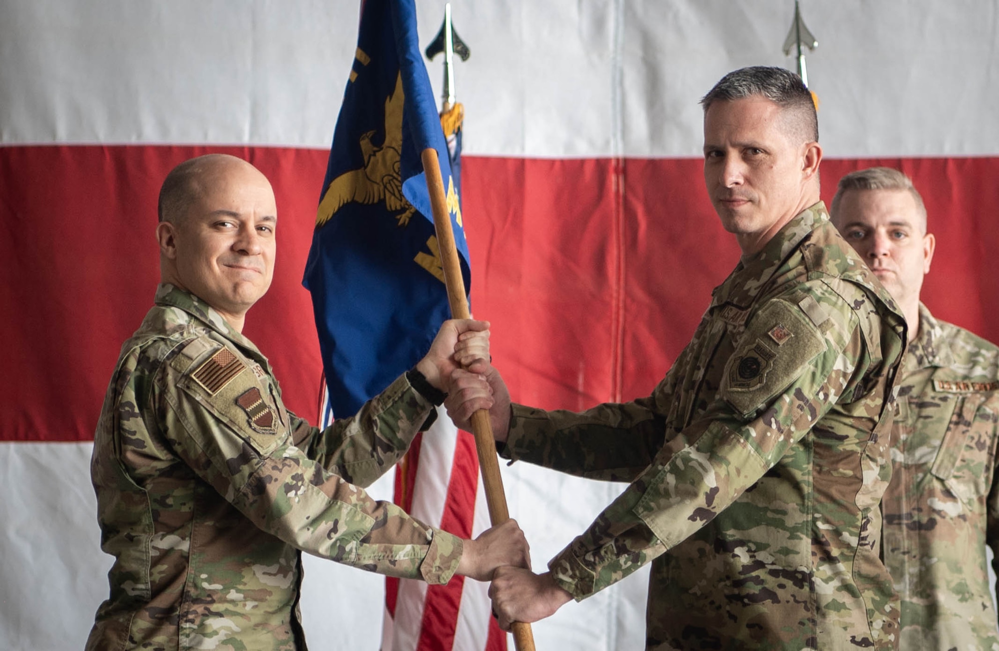 Col. Aaron Gray, 55th Wing commander, passes the guidon to incoming 55th Maintenance Group commander, Col. Eric Burke, during the 55th MXG change of command ceremony on Offutt Air Force Base, Neb., May 1, 2026. A change of command ceremony is a formal, time-honored tradition that symbolizes the official transfer or responsibility from one commanding officer to another. (U.S. Air Force photo by Daniel Martinez)