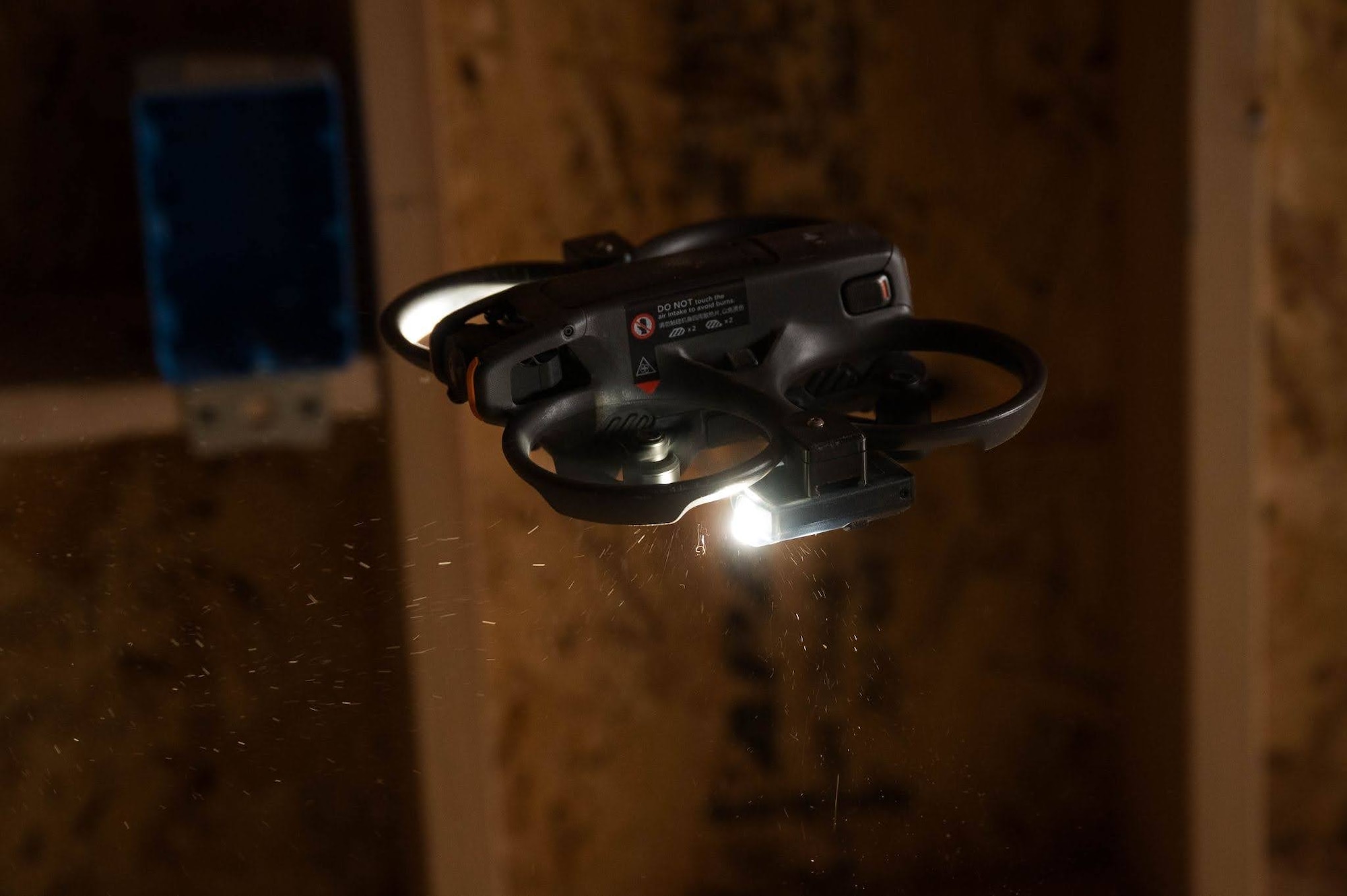 A small quadcopter drone hovers in a construction zone during a search and rescue exercise in Wasilla, Alaska, April 30, 2026. This exercise is a part of a two-day, joint operation with Joint Base Elmendorf-Richardson Explosive Ordnance Disposal where small unmanned aerial systems were used by multiple agencies to explore areas containing unexploded ordnance and hostile individuals that could put people into harm's way. (U.S. Air Force photo by Airman 1st Class Owen Davies)