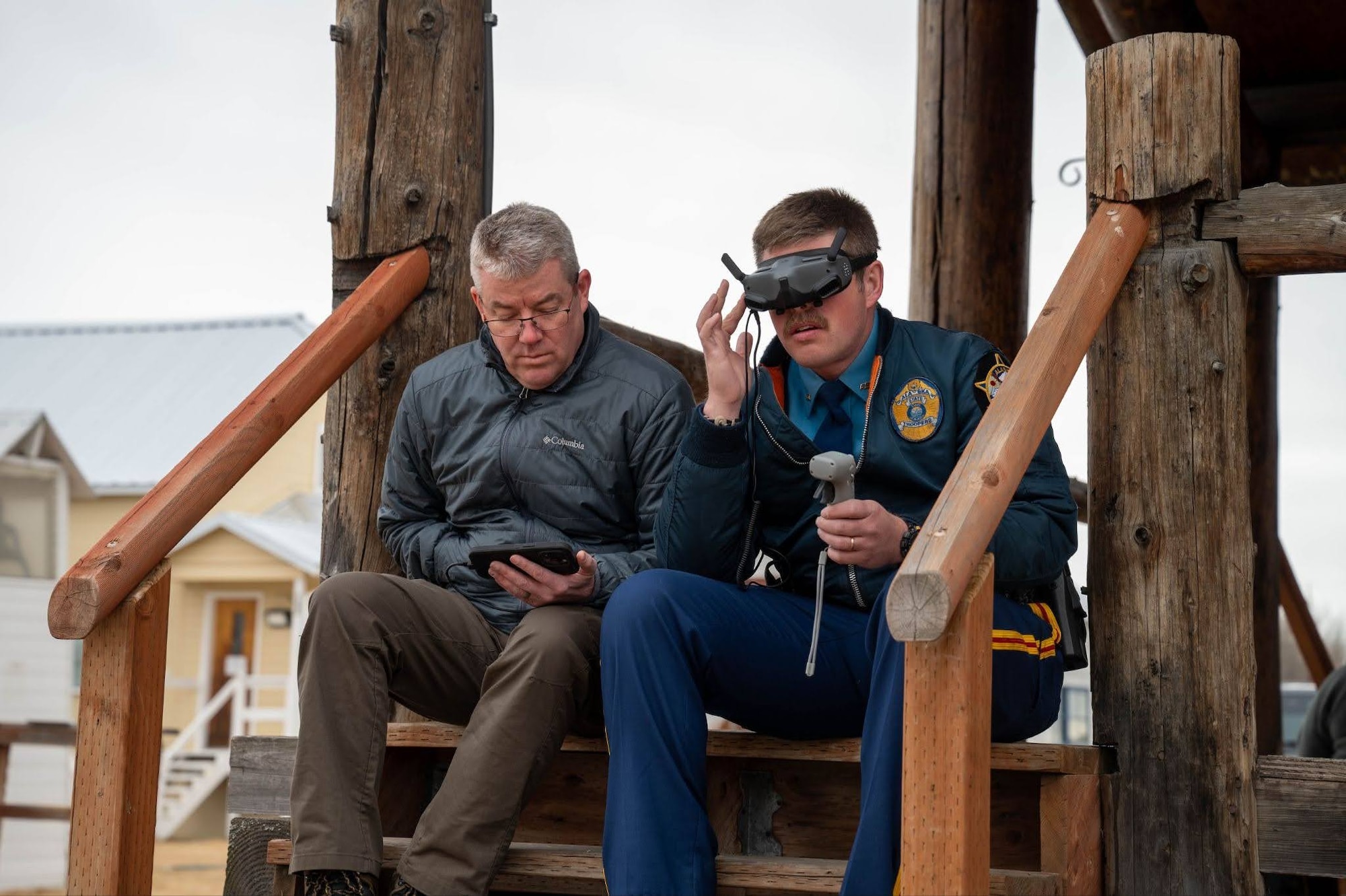 An Alaska State Trooper and Alaska Wildlife Trooper control a drone during a search and rescue exercise in Wasilla, Alaska, April 30, 2026. During this exercise, operators with Joint Base Elmendorf-Richardson Explosive Ordnance Disposal and other agencies were required to navigate through buildings and perform scanning routes to find unexploded ordnance and human objectives. (U.S. Air Force photo by Airman 1st Class Owen Davies)