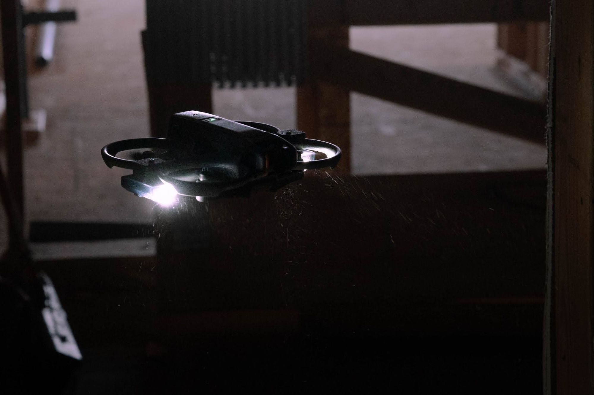 A small quadcopter drone hovers in a construction zone during a search and rescue exercise in Wasilla, Alaska, April 30, 2026. This exercise is a part of a two-day, joint operation with Joint Base Elmendorf-Richardson Explosive Ordnance Disposal where small unmanned aerial systems were used by multiple agencies to explore areas that would normally put people into harm's way. (U.S. Air Force photo by Airman 1st Class Owen Davies)