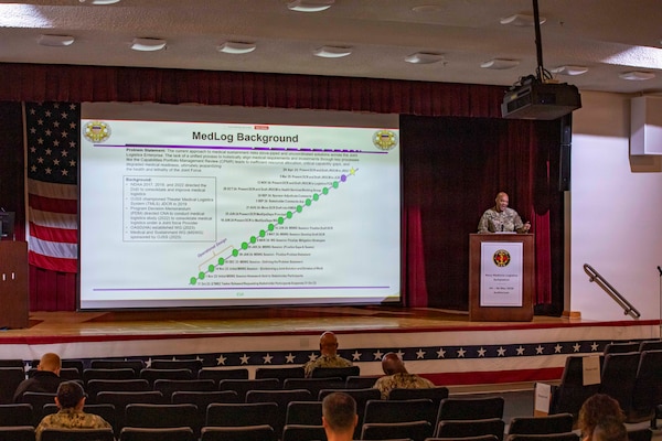 260505-N-KC192-1030 PORTSMOUTH, Va. (May 5, 2026) Lt. Col. Ronald Young, chief of the medical logistics branch of the Office of the Joint Staff Surgeon, briefs on medical logistics during the 2026 Medical Logistics Symposium held on board Naval Medical Center Portsmouth, May 5, 2026. The Navy Medicine Logistics Symposium aims to maintain a common operating picture and update the Medical Logistics community regarding the fiscal year 2026 Navy Medicine Campaign Order and the Navy MEDLOG goal to build a logistics system that delivers ready operational units to support the Naval Strategy. (U.S. Navy photo by Mass Communication Specialist Second Class Levi Decker)