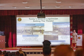 260506-N-KC192-1040 PORTSMOUTH, Va. (May 6, 2026) Lt. Cmdr. Brandi Gibson, a medical logistician and specialty leader assigned to Naval Medical Forces Atlantic, briefs on the medical logistician specialty during the 2026 Medical Logistics Symposium held on board Naval Medical Center Portsmouth, May 6, 2026. The Navy Medicine Logistics Symposium aims to maintain a common operating picture and update the Medical Logistics community regarding the fiscal year 2026 Navy Medicine Campaign Order and the Navy MEDLOG goal to build a logistics system that delivers ready operational units to support the Naval Strategy. (U.S. Navy photo by Mass Communication Specialist Second Class Levi Decker)