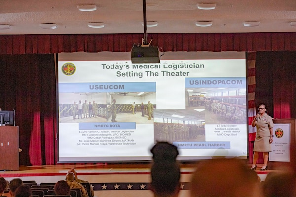 260506-N-KC192-1040 PORTSMOUTH, Va. (May 6, 2026) Lt. Cmdr. Brandi Gibson, a medical logistician and specialty leader assigned to Naval Medical Forces Atlantic, briefs on the medical logistician specialty during the 2026 Medical Logistics Symposium held on board Naval Medical Center Portsmouth, May 6, 2026. The Navy Medicine Logistics Symposium aims to maintain a common operating picture and update the Medical Logistics community regarding the fiscal year 2026 Navy Medicine Campaign Order and the Navy MEDLOG goal to build a logistics system that delivers ready operational units to support the Naval Strategy. (U.S. Navy photo by Mass Communication Specialist Second Class Levi Decker)