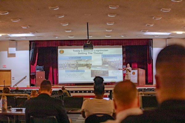 260506-N-KC192-1042 PORTSMOUTH, Va. (May 6, 2026) Lt. Cmdr. Brandi Gibson, a medical logistician and specialty leader assigned to Naval Medical Forces Atlantic, briefs on the medical logistician specialty during the 2026 Medical Logistics Symposium held on board Naval Medical Center Portsmouth, May 6, 2026. The Navy Medicine Logistics Symposium aims to maintain a common operating picture and update the Medical Logistics community regarding the fiscal year 2026 Navy Medicine Campaign Order and the Navy MEDLOG goal to build a logistics system that delivers ready operational units to support the Naval Strategy. (U.S. Navy photo by Mass Communication Specialist Second Class Levi Decker)