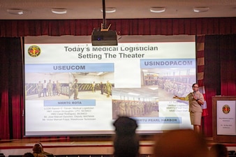 260506-N-KC192-1044 PORTSMOUTH, Va. (May 6, 2026) Lt. Cmdr. Brandi Gibson, a medical logistician and specialty leader assigned to Naval Medical Forces Atlantic, briefs on the medical logistician specialty during the 2026 Medical Logistics Symposium held on board Naval Medical Center Portsmouth, May 6, 2026. The Navy Medicine Logistics Symposium aims to maintain a common operating picture and update the Medical Logistics community regarding the fiscal year 2026 Navy Medicine Campaign Order and the Navy MEDLOG goal to build a logistics system that delivers ready operational units to support the Naval Strategy. (U.S. Navy photo by Mass Communication Specialist Second Class Levi Decker)
