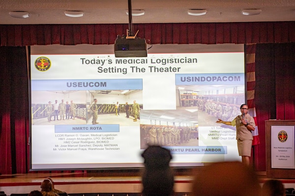 260506-N-KC192-1044 PORTSMOUTH, Va. (May 6, 2026) Lt. Cmdr. Brandi Gibson, a medical logistician and specialty leader assigned to Naval Medical Forces Atlantic, briefs on the medical logistician specialty during the 2026 Medical Logistics Symposium held on board Naval Medical Center Portsmouth, May 6, 2026. The Navy Medicine Logistics Symposium aims to maintain a common operating picture and update the Medical Logistics community regarding the fiscal year 2026 Navy Medicine Campaign Order and the Navy MEDLOG goal to build a logistics system that delivers ready operational units to support the Naval Strategy. (U.S. Navy photo by Mass Communication Specialist Second Class Levi Decker)
