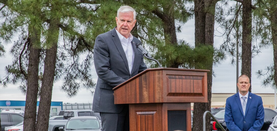 man standing at a podium with a microphone