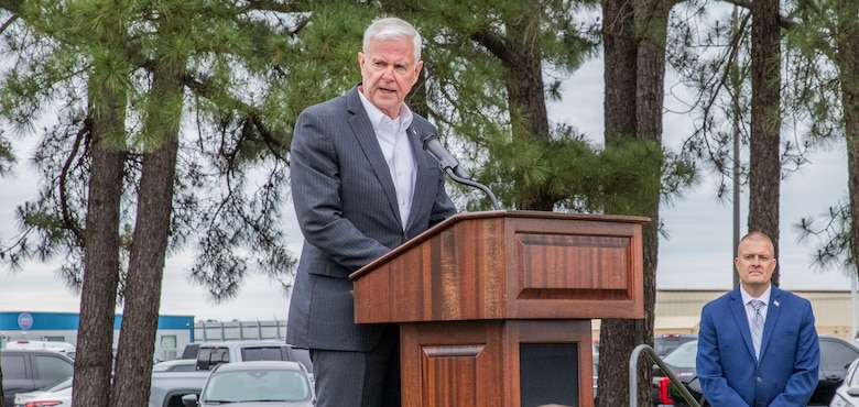 man standing at a podium with a microphone