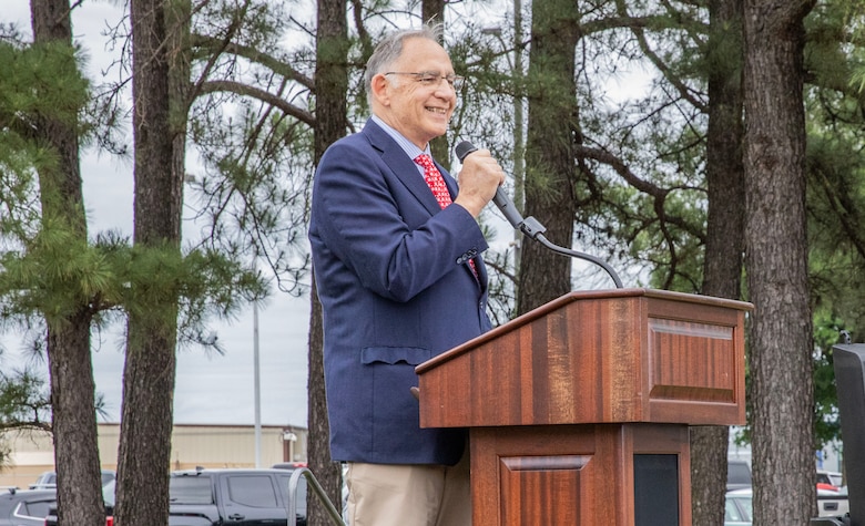man standing at a podium with a microphone
