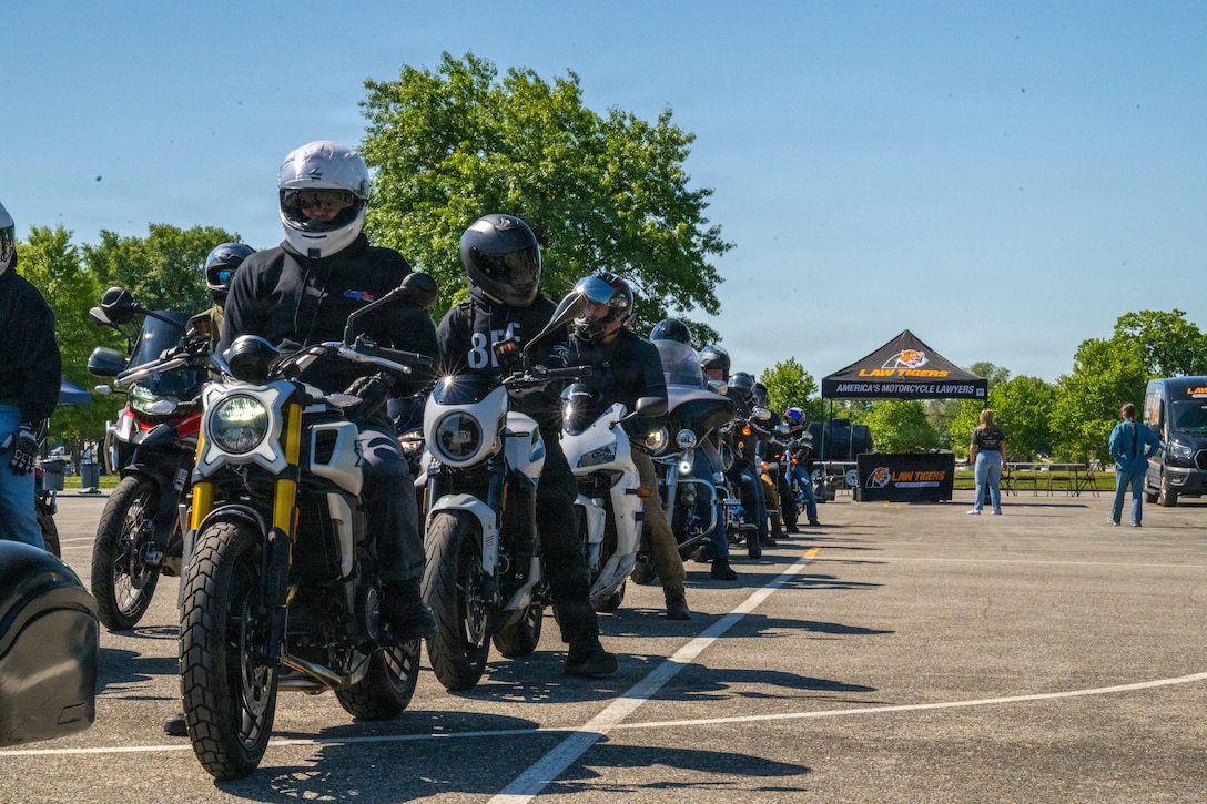 People on motorcycles in a line formation.