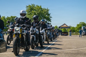 People on motorcycles in a line formation.