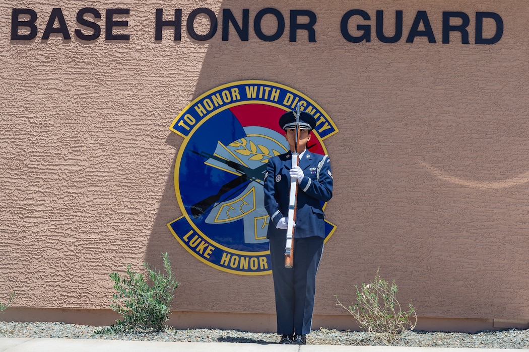 U.S. Air Force Senior Airman Mickaella Badilla, a 56th Force Support Squadron Honor Guard ceremonial guardsman, stands at present arms during a ribbon cutting ceremony held for the new Honor Guard facility at Luke Air Force Base, Arizona, May 7, 2026.