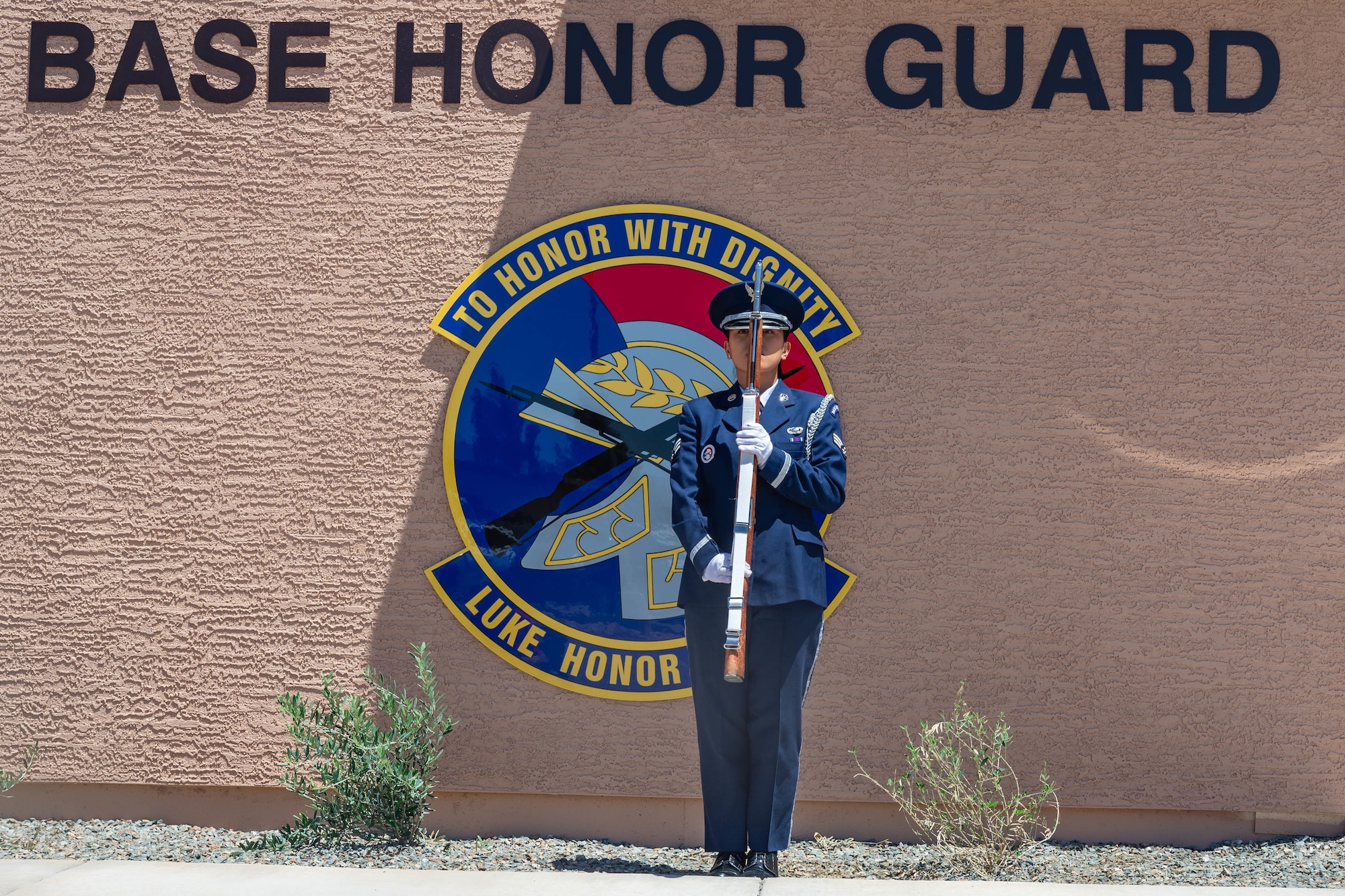 U.S. Air Force Senior Airman Mickaella Badilla, a 56th Force Support Squadron Honor Guard ceremonial guardsman, stands at present arms during a ribbon cutting ceremony held for the new Honor Guard facility at Luke Air Force Base, Arizona, May 7, 2026.