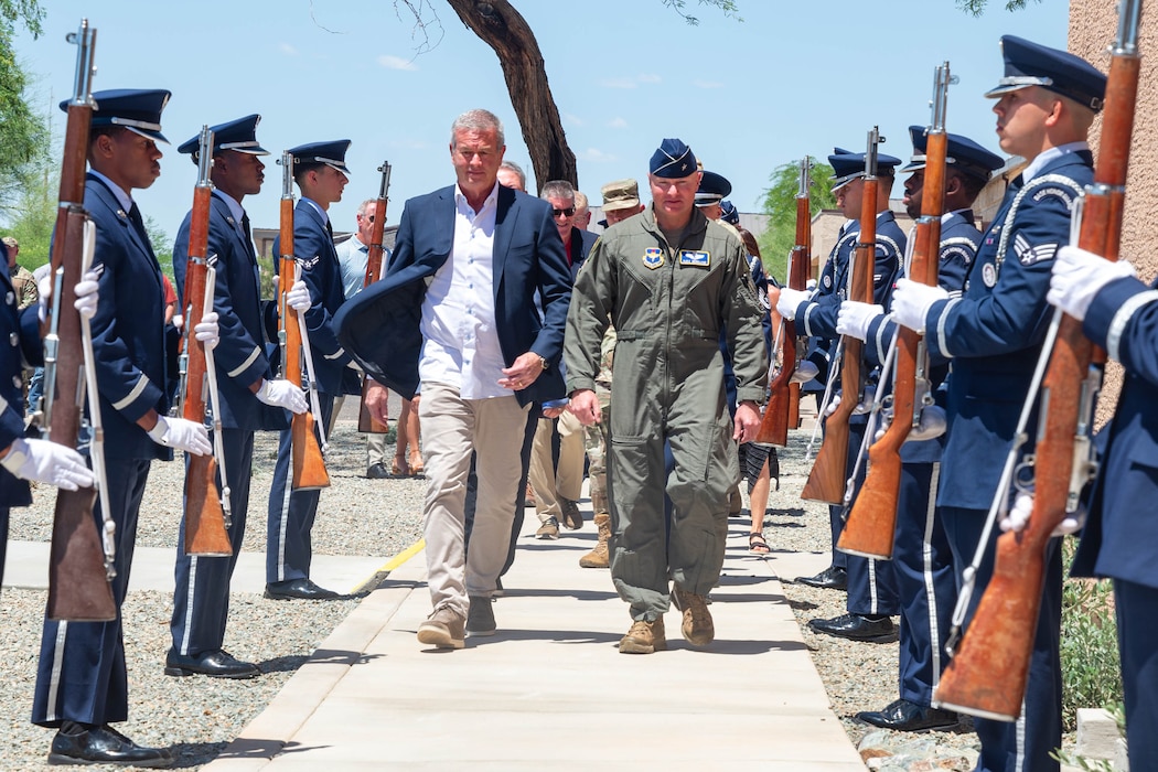 U.S. Air Force Brig. Gen. David Berkland, 56th Fighter Wing commander, right, and Jeff Gordon, CEO of IDM companies, walk through a cordon during a ribbon cutting ceremony held for the new Honor Guard facility at Luke Air Force Base, Arizona, May 7, 2026.